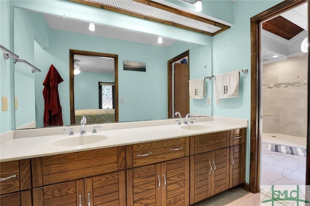 ensuite bathroom with double vanity, a sink, and ensuite bathroom