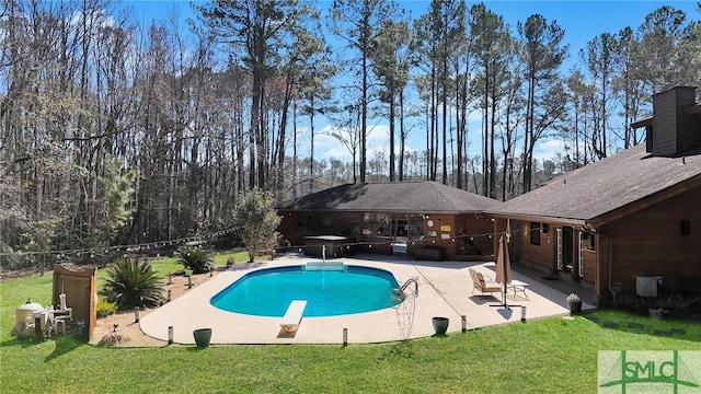 outdoor pool featuring a patio area, grilling area, a diving board, and a yard