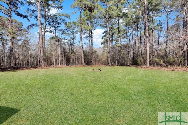 view of yard featuring a view of trees