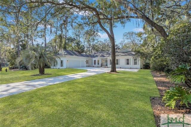 view of front of home featuring a front lawn, concrete driveway, and an attached garage