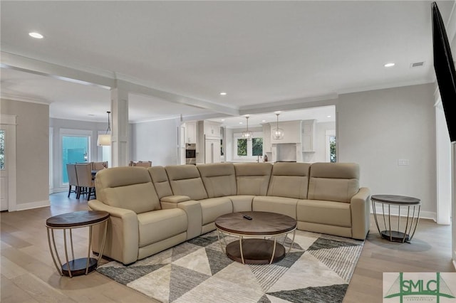 living area featuring ornamental molding, recessed lighting, light wood-style floors, and baseboards