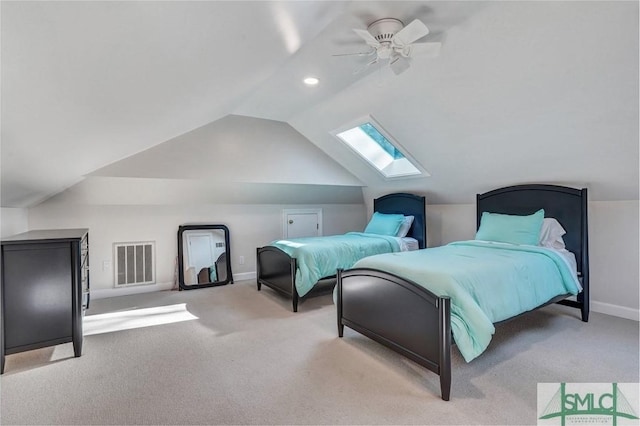 bedroom with vaulted ceiling with skylight, baseboards, visible vents, a ceiling fan, and carpet floors