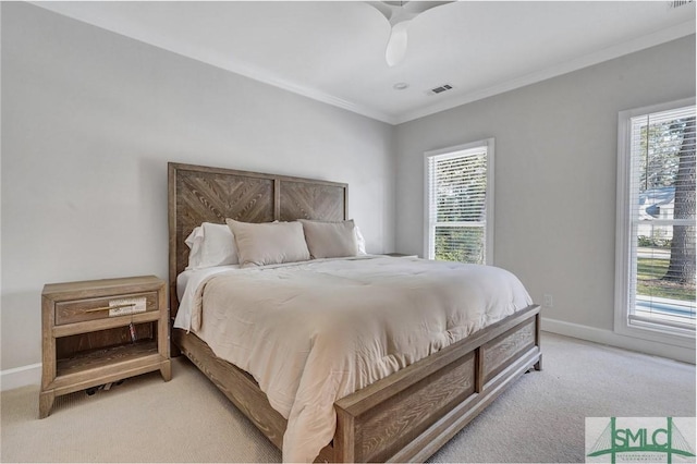 bedroom featuring crown molding, baseboards, visible vents, and light colored carpet