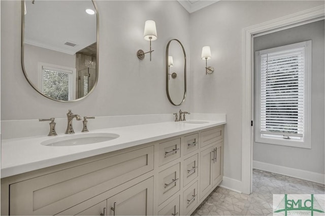 full bathroom featuring double vanity, ornamental molding, a sink, and baseboards