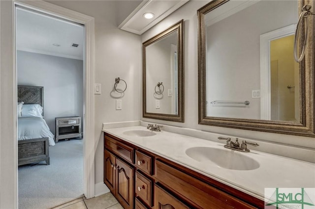 full bath with double vanity, tile patterned flooring, a sink, and ensuite bathroom