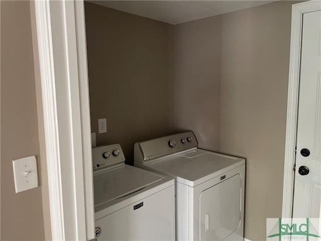 clothes washing area with laundry area and washing machine and clothes dryer