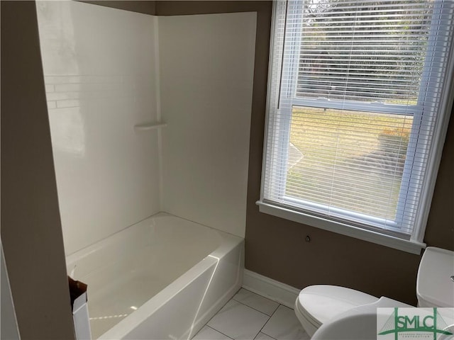 bathroom featuring baseboards, a healthy amount of sunlight, and toilet