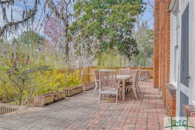 view of patio / terrace featuring outdoor dining area and fence