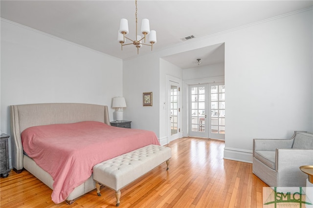 bedroom featuring visible vents, ornamental molding, access to outside, french doors, and light wood-type flooring