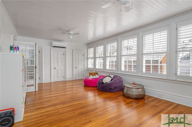 interior space with plenty of natural light, ceiling fan, and an AC wall unit