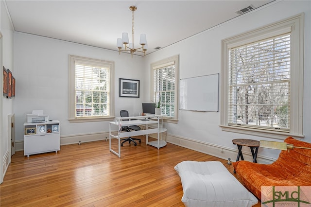 home office with an inviting chandelier, light wood-style flooring, visible vents, and baseboards