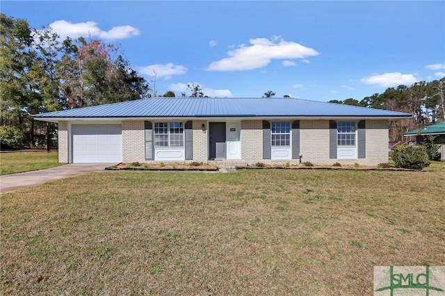 ranch-style home with a garage, driveway, metal roof, a front lawn, and brick siding