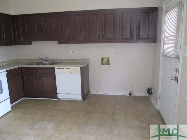 kitchen with white appliances, light countertops, and a sink