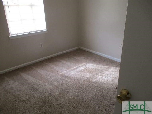 carpeted spare room with baseboards