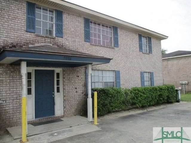 view of front of home featuring brick siding