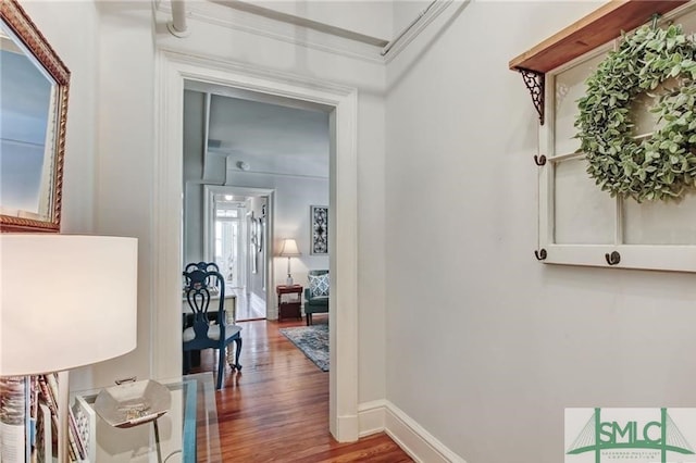 hall with wood finished floors and baseboards