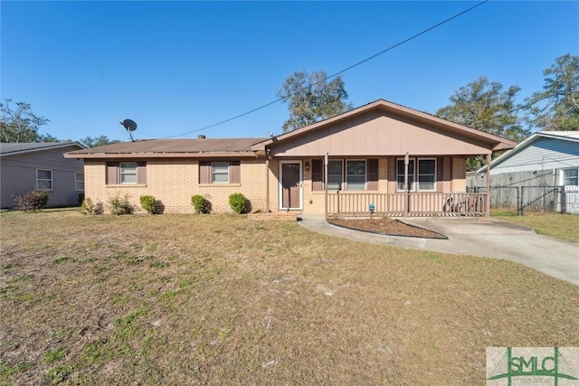 ranch-style house with fence, a front lawn, a porch, and brick siding