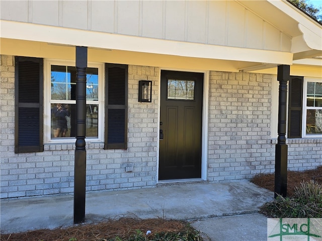 property entrance with brick siding