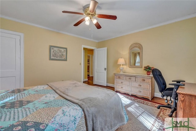 bedroom featuring ornamental molding, ceiling fan, baseboards, and wood finished floors