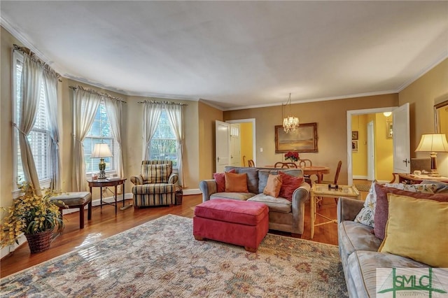 living area with crown molding, baseboards, and wood finished floors