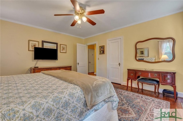 bedroom featuring ornamental molding, a ceiling fan, baseboards, and wood finished floors