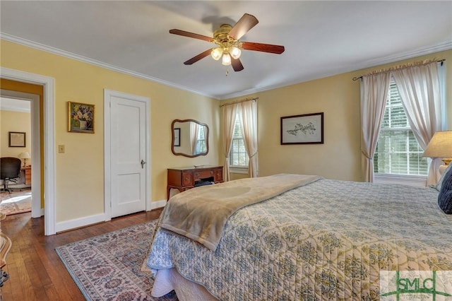 bedroom featuring baseboards, ceiling fan, wood-type flooring, and crown molding