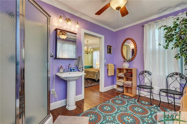 full bath with ornamental molding, ceiling fan, a shower stall, wood finished floors, and baseboards