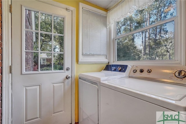 laundry room with laundry area and washing machine and clothes dryer