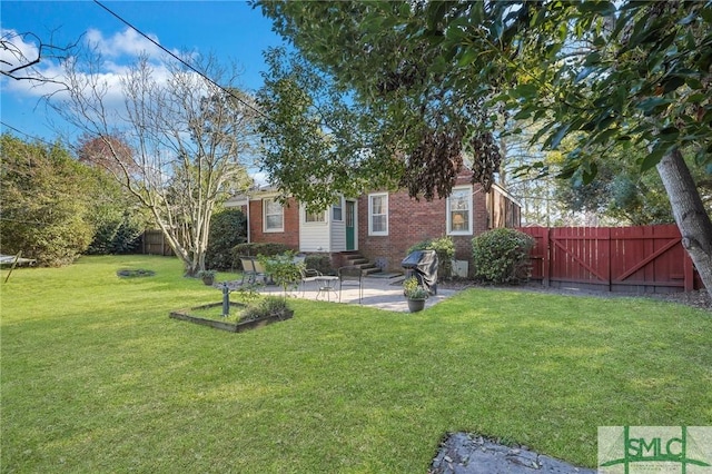 view of yard featuring entry steps, a patio, fence, and a gate