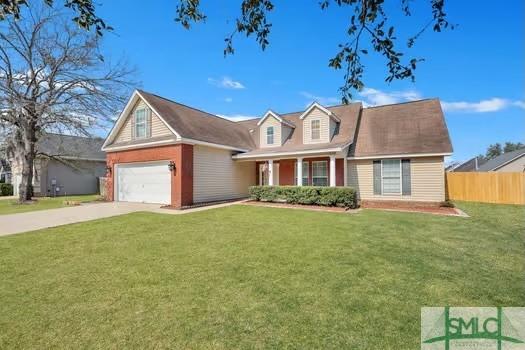 view of front of home featuring a front yard, fence, and driveway