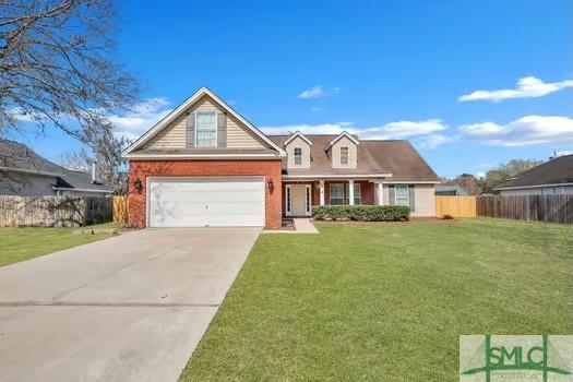 view of front of house with brick siding, fence, a garage, driveway, and a front lawn