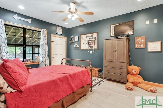 720 Old Dixie Hwy S, Springfield, GA 31329 - bedroom with light wood-style floors, ceiling fan, baseboards, and a textured ceiling
