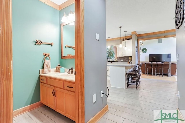 720 Old Dixie Hwy S, Springfield, GA 31329 - bathroom featuring baseboards, visible vents, decorative backsplash, and vanity