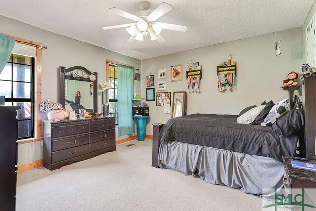 720 Old Dixie Hwy S, Springfield, GA 31329 - carpeted bedroom with a textured ceiling, ceiling fan, and baseboards