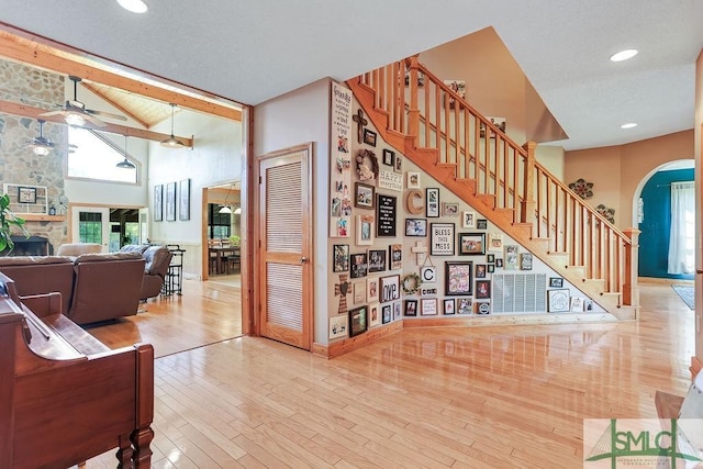 720 Old Dixie Hwy S, Springfield, GA 31329 - living room with arched walkways, stairway, a fireplace, and wood finished floors