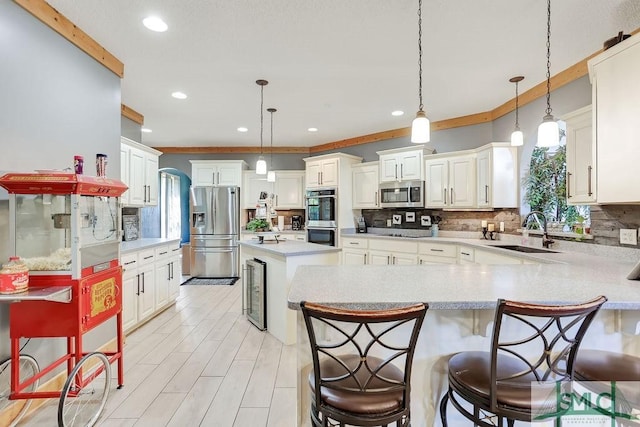 720 Old Dixie Hwy S, Springfield, GA 31329 - kitchen featuring beverage cooler, stainless steel appliances, a sink, light countertops, and tasteful backsplash