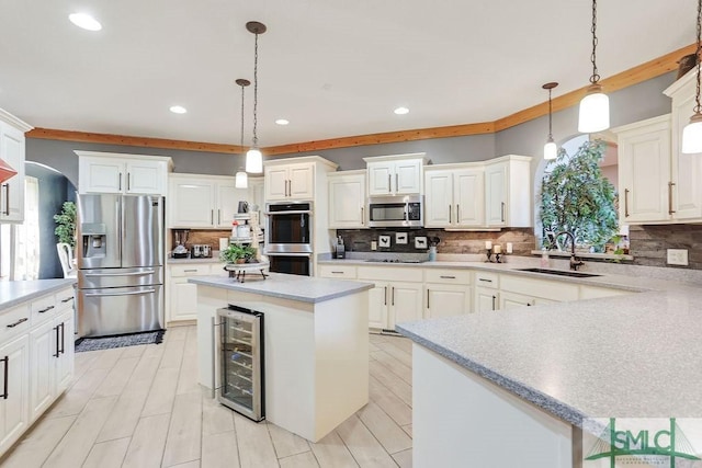 720 Old Dixie Hwy S, Springfield, GA 31329 - kitchen with wine cooler, tasteful backsplash, light countertops, appliances with stainless steel finishes, and a sink