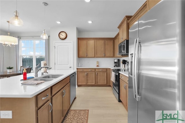 kitchen featuring appliances with stainless steel finishes, brown cabinets, light countertops, pendant lighting, and a sink