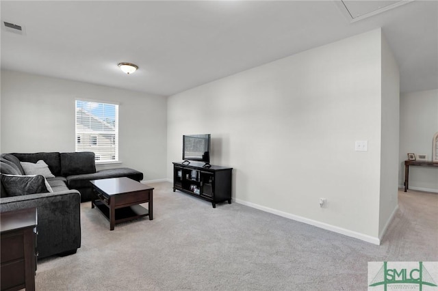 living area featuring visible vents, light carpet, and baseboards