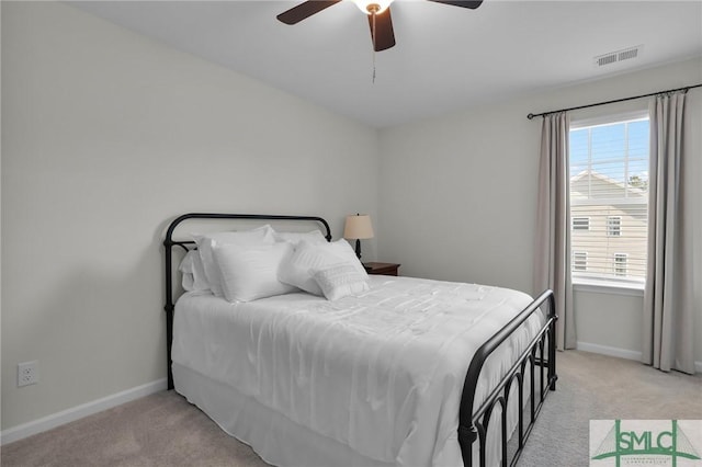 bedroom with visible vents, ceiling fan, light carpet, and baseboards