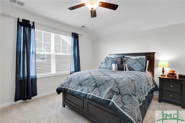 bedroom featuring lofted ceiling, light colored carpet, visible vents, ceiling fan, and baseboards