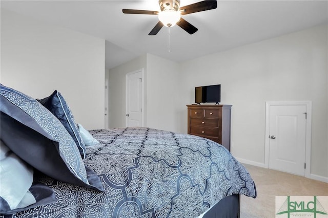 carpeted bedroom with a ceiling fan and baseboards