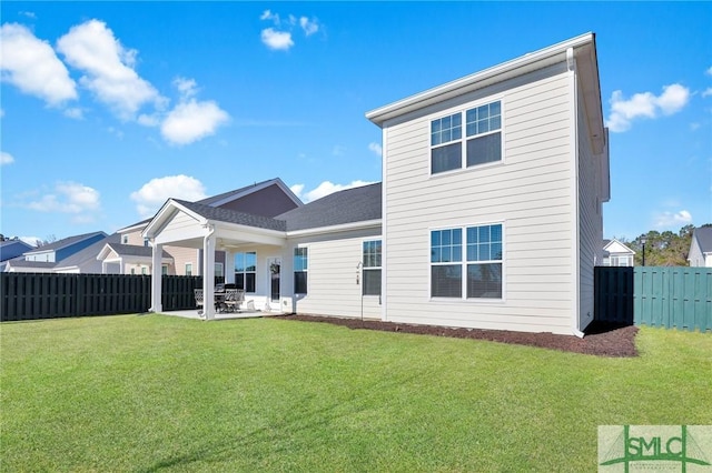 back of house featuring a fenced backyard, a lawn, and a patio