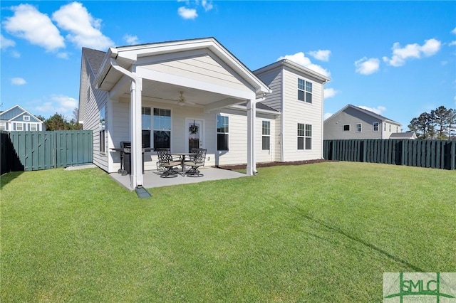 rear view of property featuring a fenced backyard, ceiling fan, a patio, and a lawn