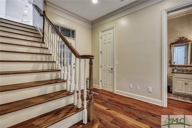 entrance foyer with crown molding, stairs, baseboards, and wood finished floors