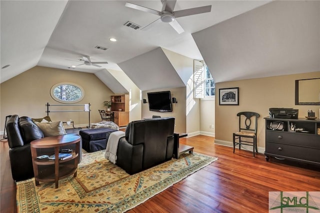 living room with lofted ceiling, a healthy amount of sunlight, visible vents, and wood finished floors