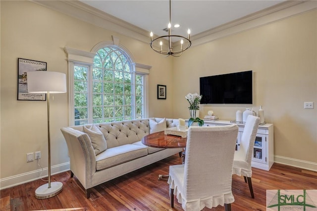 living room with an inviting chandelier, baseboards, ornamental molding, and wood finished floors