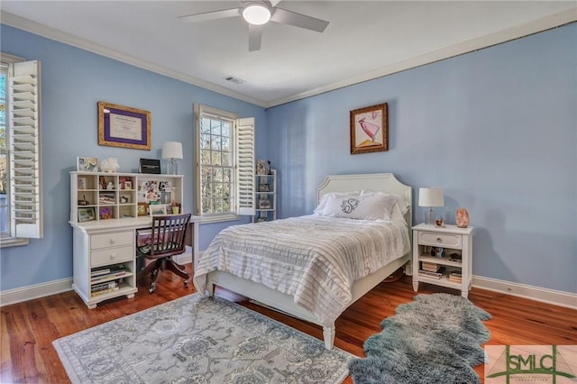 bedroom featuring baseboards, visible vents, ornamental molding, and wood finished floors