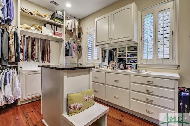 spacious closet featuring visible vents and wood finished floors