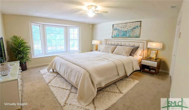 bedroom featuring light carpet, ceiling fan, visible vents, and baseboards